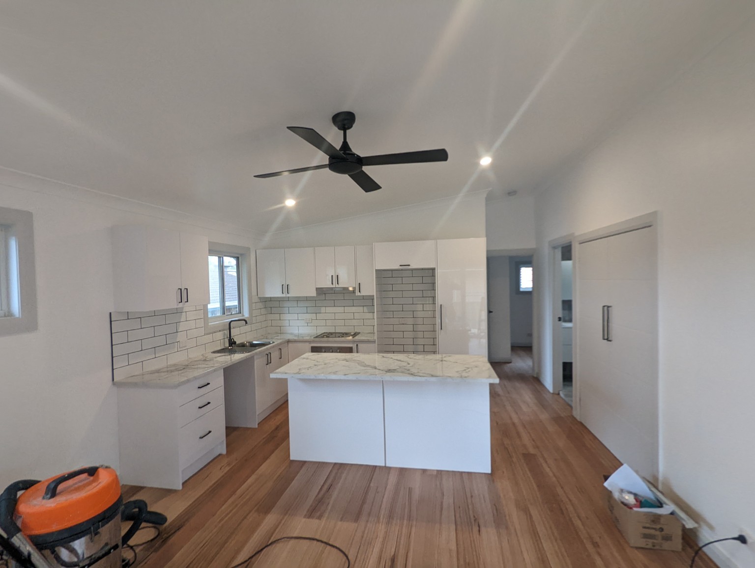 East Gosford granny flat — Open-plan kitchen and living area during finishing works