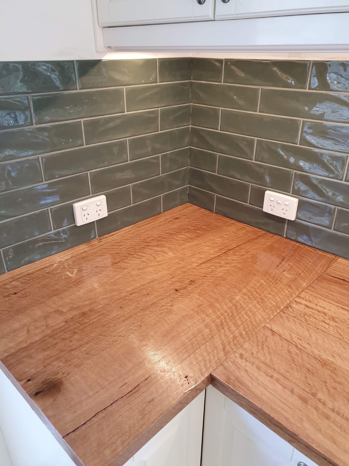 Holgate renovation — Kitchen timber benchtop and green tiled splashback