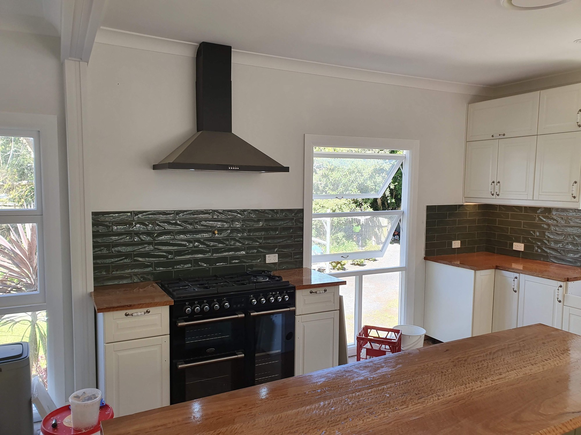 Holgate renovation — Kitchen renovation with white cabinetry and timber benchtops